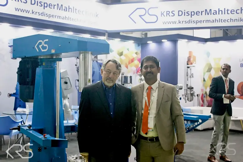 KRS DISPERMAHLTECHNIK team on the KRS DISPERMAHLTECHNIK stand at ECS 2025 beside a High Speed Dissolver