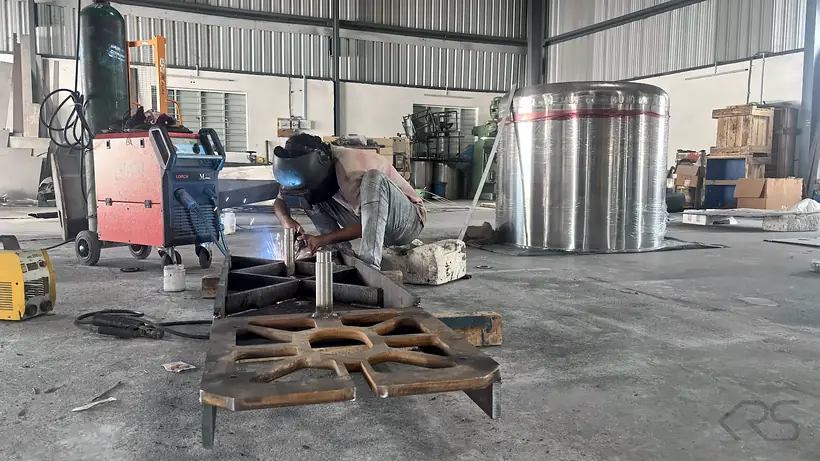 Welder fabricating a steel base structure at KRS