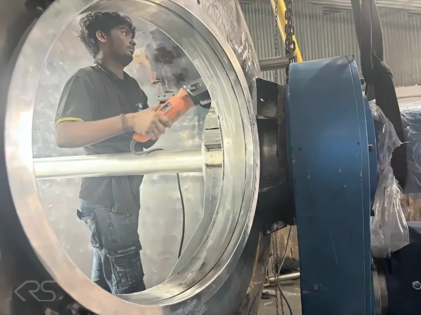 Technician finishing the interior of a mixer vessel at KRS